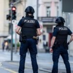 Police officers patroll a street in downtown Aarau