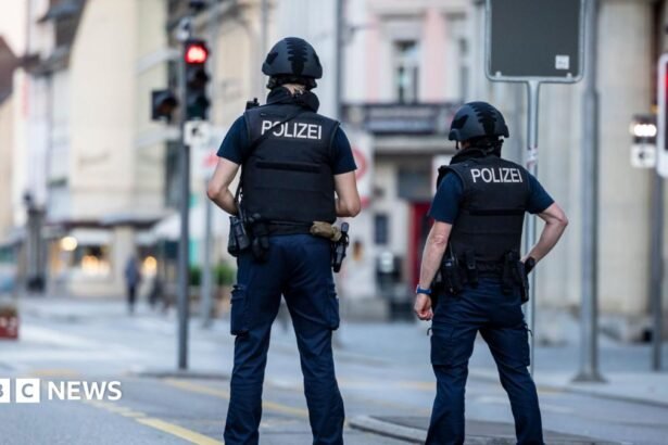 Police officers patroll a street in downtown Aarau