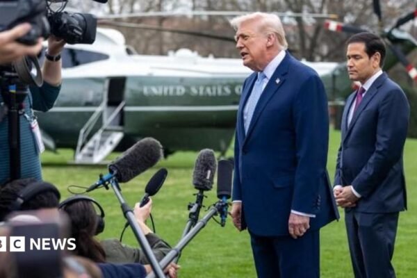 Donald Trump and Marco Rubio speaking to reporters on the White House lawn. The presidential helicopter is in the background.