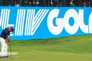 Golfer Bryson DeChambeau putts in front of a big blue and white LIV Golf sign