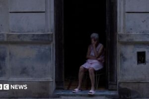 People play dominoes in  dark outdoor space  during a blackout in Havana.