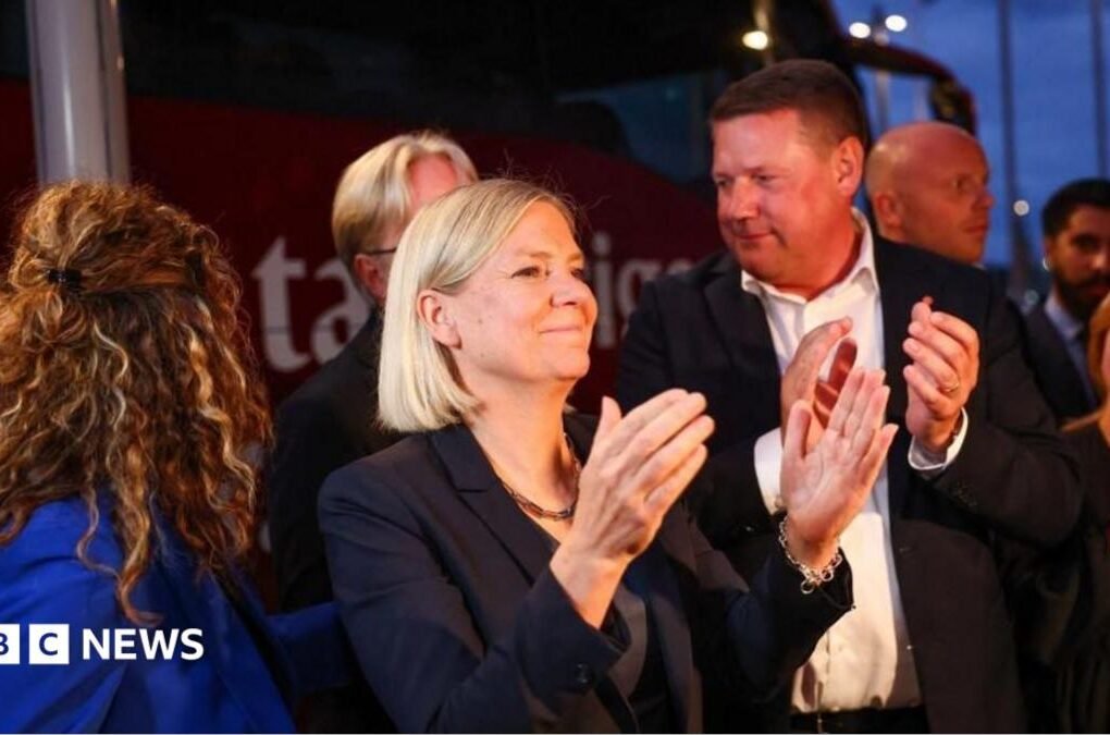 Sweden's Social Democratic Party leader, Magdalena Andersson applauds as she waits with other party members for general election results