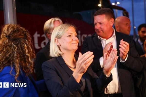 Sweden's Social Democratic Party leader, Magdalena Andersson applauds as she waits with other party members for general election results